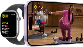 Apple Watch next to iPhone with Apple Fitness+ class on screen
