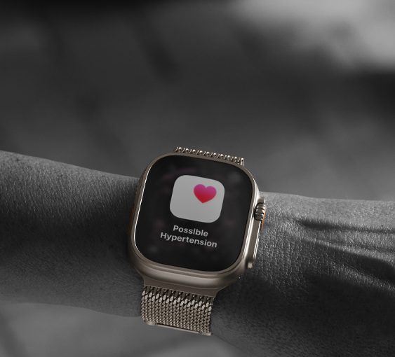 Person wearing Apple Watch Ultra 3 on wrist, possible hypertension health alert screen