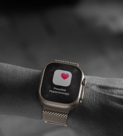 Person wearing Apple Watch Ultra 3 on wrist, possible hypertension health alert screen